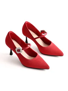 Detailed view of red knitted Mary Jane heels with rhinestone buckle and pointed toe.