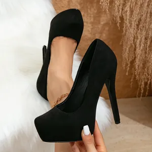 Close-up of black suede platform high heels with a round toe and sleek stiletto.