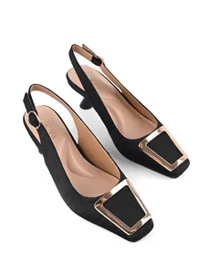 Close-up of black square toe slingback sandals with elegant gold metal buckle detail