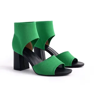 Detail shot of green fly-knit chunky heel sandals with breathable open-toe design