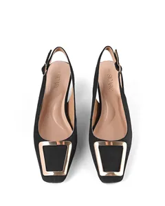 Detailed top view of black square-toe slingback sandals featuring a bold gold metal buckle