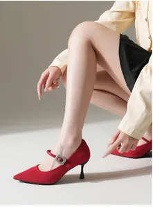 Detailed view of elegant red pointed toe Mary Jane pumps with thin stiletto heels.