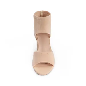 Detailed front view of breathable beige flyknit open-toe sandals with chunky high heels