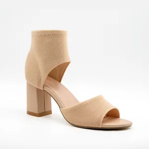 Elegant nude fly-knit block heel sandals with open toe and sock-style ankle strap detail.