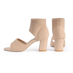 Close-up of beige fly-knit peep toe sandals with comfortable chunky high heels