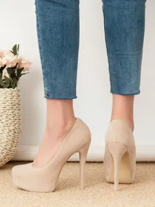 Rear view of elegant beige suede platform high heels with stilettos and round toes