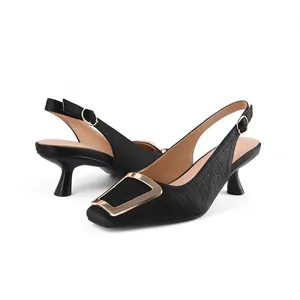 Elegant black slingback heels with square gold buckle and embossed leather texture