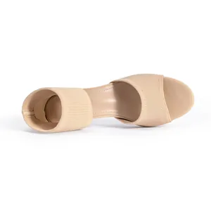 Top view of beige flyknit peep toe block heel sandal showing knit texture and interior.