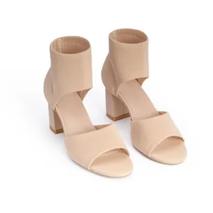 Detailed view of beige knit peep toe block heel sandals with a comfortable ankle cuff