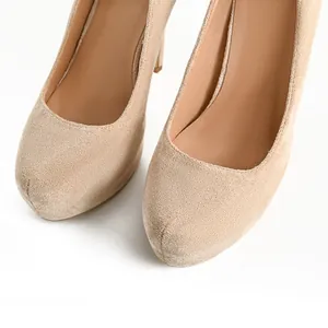 Macro detail of suede platform high heels showing the elegant round toe design