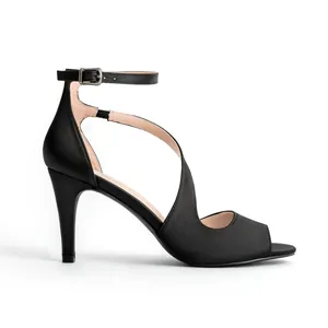 Close-up detail view of elegant black peep-toe stiletto heels with ankle straps.