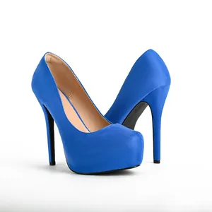 Close-up of royal blue suede high-heeled platform pumps with thin stiletto heels.