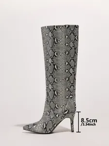 Side view detail showing the 8.5cm stiletto heel on trendy snake print knee-high boots