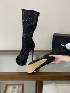 Close-up of black rhinestone mesh thigh-high boots with peep-toe and stiletto heel