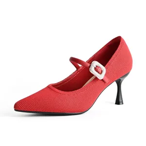 Elegant red pointed-toe Mary Jane pumps featuring a rhinestone buckle and kitten heel.