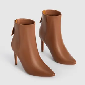 Side view of elegant tan pointed-toe stiletto ankle boots with leather texture