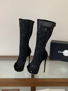 Detailed side view of black mesh peep-toe high heel boots featuring silver rhinestones