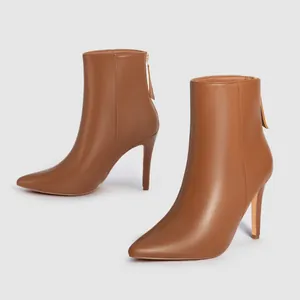 Side view of elegant brown pointed-toe stiletto ankle boots with rear zipper detail.