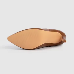 Detailed view of the non-slip sole and stiletto heel of a brown pointed-toe boot.