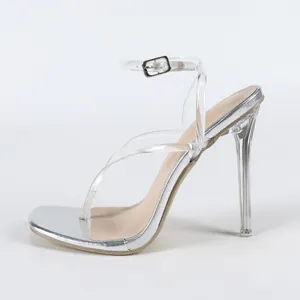 Profile of silver high heel sandals with clear PVC thin straps and a stiletto heel.