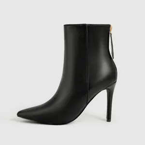 Detailed side profile of a stylish black pointed-toe ankle boot featuring a high stiletto heel