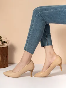 Elegant apricot pointed toe stiletto pumps shown on feet for professional formal wear