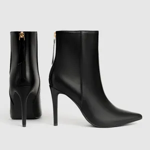Elegant black pointed toe ankle boots with high stiletto heels and back zipper detail.