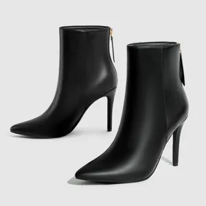 Elegant black stiletto ankle boots featuring a sharp pointed toe and back zipper closure