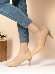 Detailed side view of apricot pointed-toe stiletto heels for formal occasions.