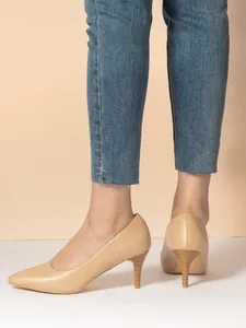 Back view of elegant apricot leather pointed-toe stiletto pumps worn with blue jeans