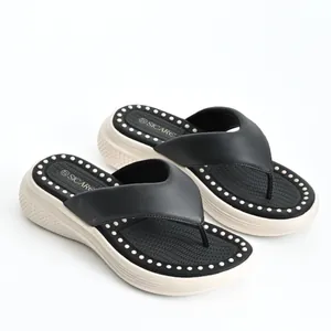 Stylish black platform flip-flops for women with cream wedge sole on white background
