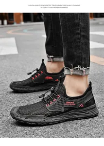 Detailopname van zwarte ademende mesh sneakers met elastische veters en rode accenten