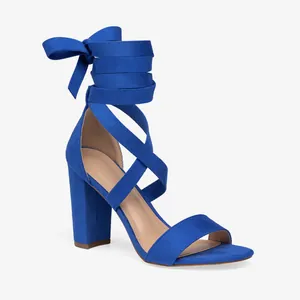 Cobalt blue suede block heel sandals with cross lace-up straps and bow detail.