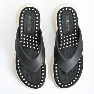 Detail of women flip-flops with massage footbed and SICARE branding on the sole