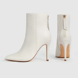 Elegant white pointed toe stiletto ankle boots featuring back zipper closure for women.
