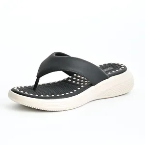 Side view of women's black and white platform flip-flops featuring a massage footbed