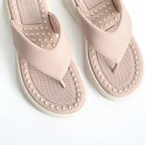 Detail of pink platform flip-flops with massage footbed and soft leather straps