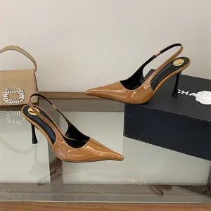 Detail view of stylish brown patent leather pointed toe slingback high heel pumps.
