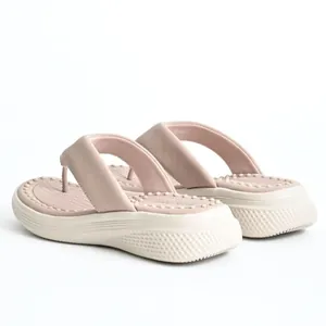 Back angle detail of women's platform flip-flops with massage footbed and thick sole