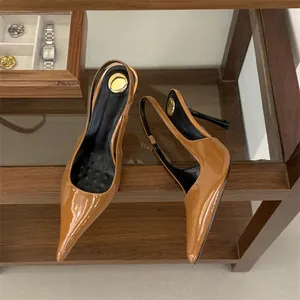 Detail view of brown patent leather slingback heels with unique rose flower heel