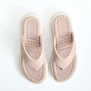 Top view of comfortable pink platform flip-flops featuring a massage textured footbed