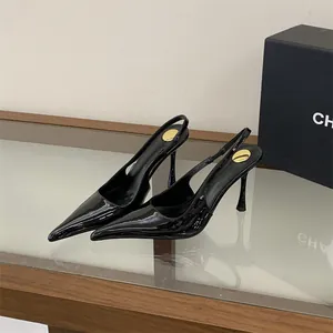 Detailed view of elegant black patent leather pointed-toe slingback heels with thin high heels