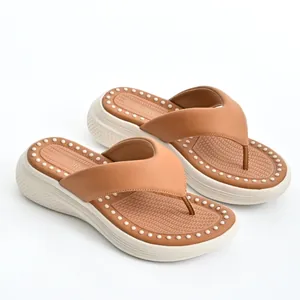 Tan platform flip-flops with soft massage cushion and white studded trim