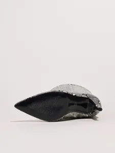 Detailed macro view of snake-print high-heeled boot featuring black sole and size 37 mark