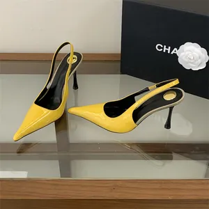 Detail of yellow patent leather slingback pumps with pointed toe and stiletto heel