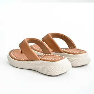 Side view of women's platform flip-flops showing brown straps and massage footbed texture
