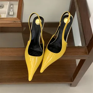 Close-up of vibrant yellow patent leather pointy toe slingback high heels on shelf