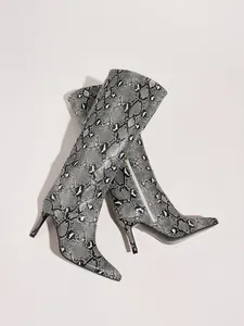 Detailed view of grey snakeskin knee-high boots with stiletto heel and pointed toe