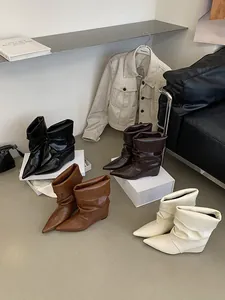Collection of stylish pointed toe wedge slouchy mid-calf boots in various chic colors.