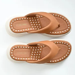 Top view detail of camel platform thong sandals featuring a comfortable massage insole design